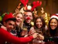 Group Of Friends Enjoying Christmas Drinks In Bar