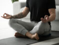 A man meditates in the comfort of his own home.