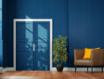 This decked out doorway has been given an elegant silver handle and a royal blue color to match the room around it.