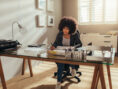 Woman working productively and happily from the comfort of her own home.