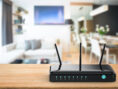 Black wi-fi router inside a modern apartment unit.