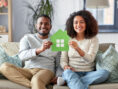 Happy couple relaxes on the couch in their eco-friendly home.