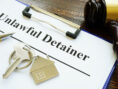 Unlawful detainer papers, key and gavel in the court.