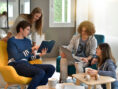 Group of co-op living mates enjoys time together in a communal living space.