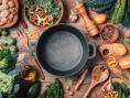 Several colorful cooking utensils and ingredients spread out across a tabletop.