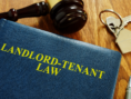 landlord tenant lawbook with keys and gavel.