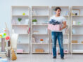 Man tidies up the living area in his apartment.